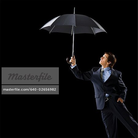 Young man holding an umbrella.