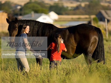 woman, girl, and a horse