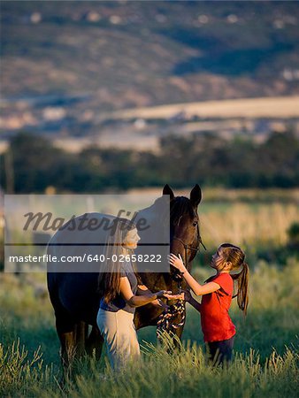 woman, girl, and a horse