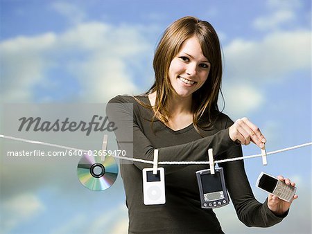 woman hanging electronics out to dry