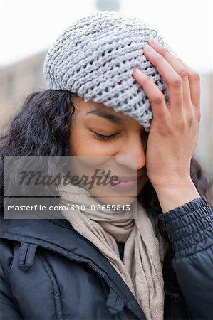 Woman Smiling and Pulling Hat Over Her Eyes, Portland, Oregon, USA