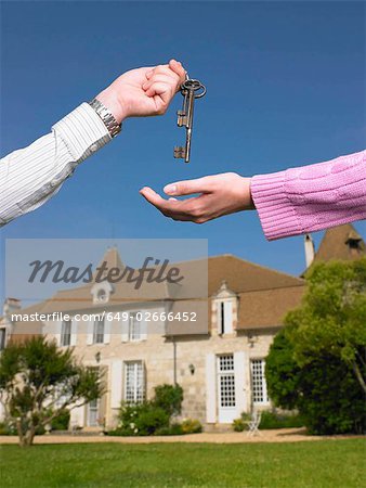 Woman receiving keys to country home