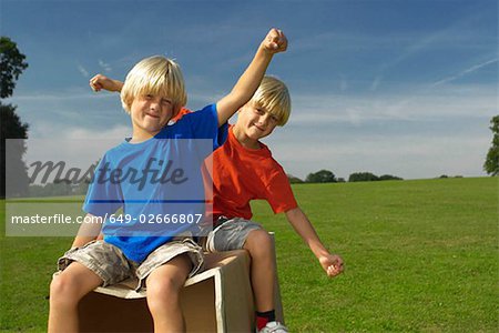 boys on a box, arms out