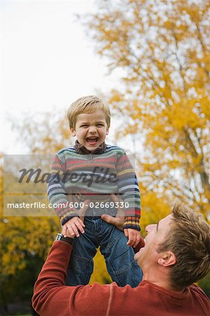 Father Lifting Son Up in the Air, Portland, Oregon, USA