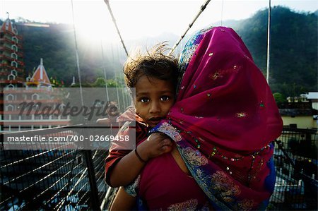 Mother Carrying Son Across Bridge, Rishikesh, India