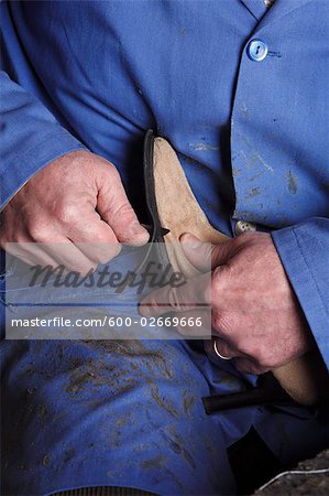 Italian Shoemaker Cutting Edge of Sole on Boot