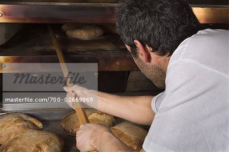 Baker Taking Bread out of Oven, Cerreto Laziale, Rome, Italy