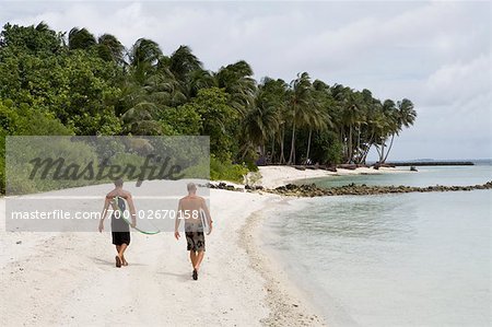 Surfers on the Beach at Chickens Surf Break, North Male Atoll, Maldives