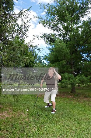 Golfer Looking for Ball in Rough, Burlington, Ontario, Canada