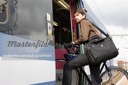 Man with bike getting onto train