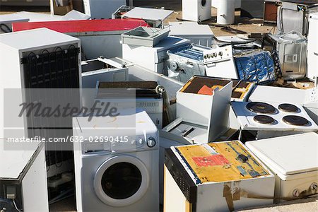 Discarded appliances in junkyard, full frame