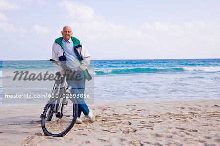 Man With Bicycle on the Beach