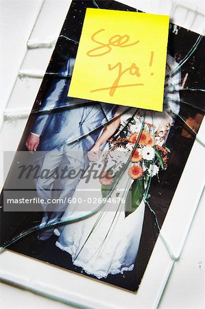 Smashed Wedding Photo With See Ya Written on a Sticky Note
