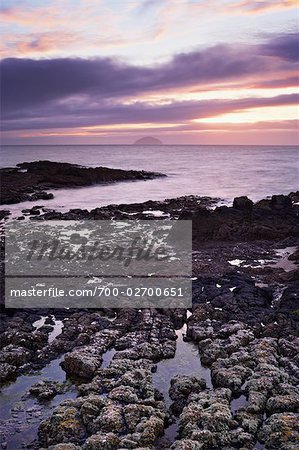 View Across Rocky Shoreline to the Island of Ailsa Craig at Sunset, Turnberry Point, South Ayrshire, Ayrshire, Scotland