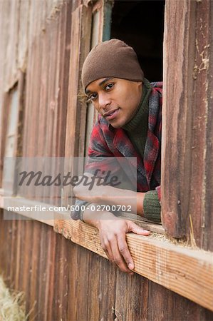 Portrait of Man Leaning Out Barn Window on a Farm in Hillsboro, Oregon, USA
