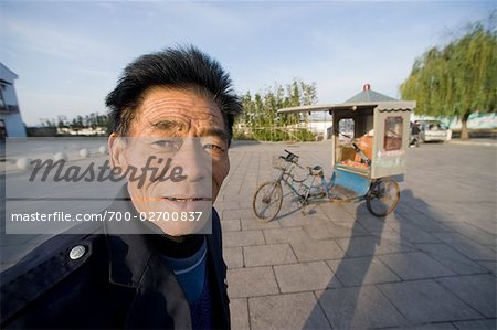 Porträt des Mannes, Rikscha im Hintergrund, Zhouzhuang, Jiangsu, China