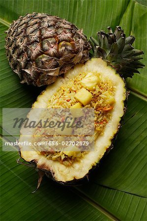 pineapple rice in fruit shell on banana leaf