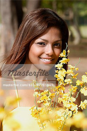 woman holding flowers, smiling