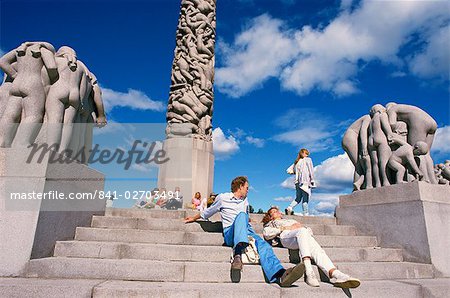 People relaxing on steps before sculptures on the central stele in Frogner Park (Vigeland's Park), Oslo, Norway, Scandinavia, Europe