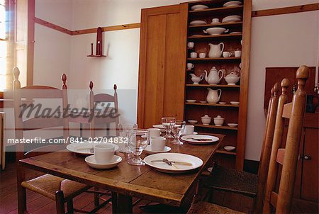 Interior with table, chairs, white china and cupboard in the Shaker Village of Hancock, Massachusetts, New England, United States of America, North America