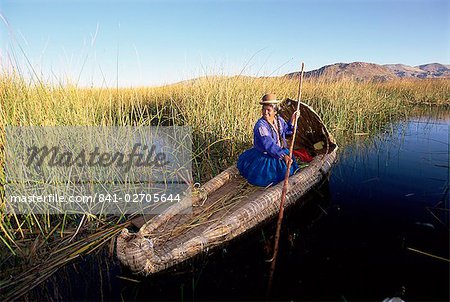 A Uros Indian woman in a traditional reed boat, Islas Flotantes, floating islands, Lake Titicaca, Peru, South America