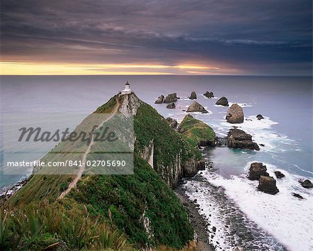 Nugget Point lighthouse on the coast and overcast sky, the Catlins, South Island, New Zealand, Pacific