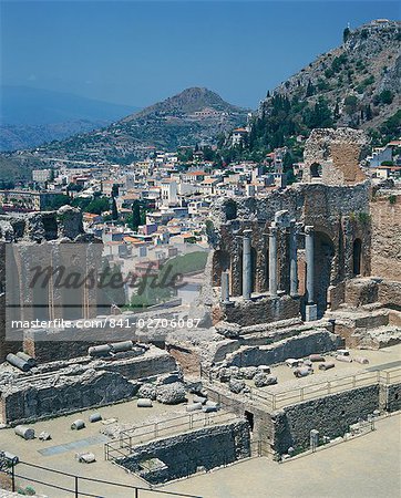 The ruins taken from the Greek Roman theatre, and the town in the background, at Taormina on the island of Sicily, Italy, Europe