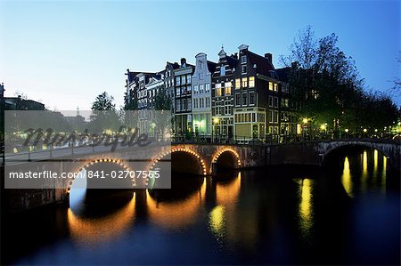 Canals, illuminated bridges and traditional buildings at night, Amsterdam, Holland, Europe