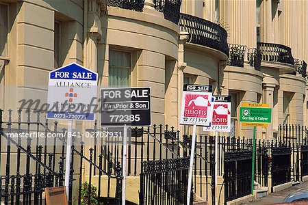 For sale signs outside Georgian terrace, Brighton and Hove, Sussex, United Kingdom, Europe