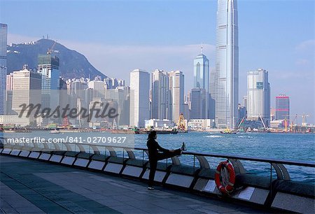 Morning exercise, Victoria Harbour and Hong Kong Island skyline, Hong Kong, China, Asia