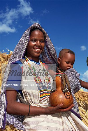 Mother holding baby and gourd, Ethiopia, Africa
