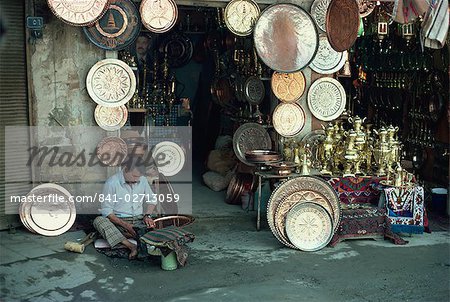 Man working on copper plate outside a copper souk, Baghdad, Iraq, Middle East