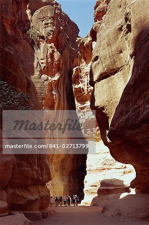 The Siq, narrow entrance between rock cliffs, to the site of Petra, UNESCO World Heritage Site, Jordan, Middle East