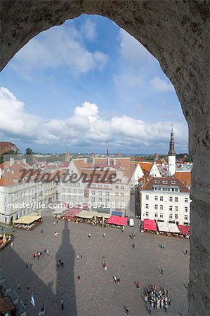 Tourists in the Old Town square with cafe canopies, Tallinn, Estonia, Baltic States, Europe