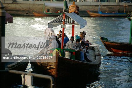People on a local ferry boat in Dubai Creek, Dubai, UAE