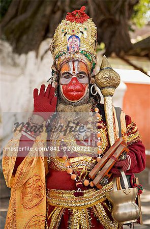 A supposed Holy man dressed as Hanuman, the Hindu monkey god, posing for photographs, Durbar Square, Kathmandu, Nepal, Asia