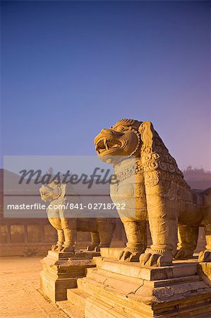 Stone lions, Durbar Square, Bhaktapur, Kathmandu valley, Nepal. Foggy winter dawn, november 2005.