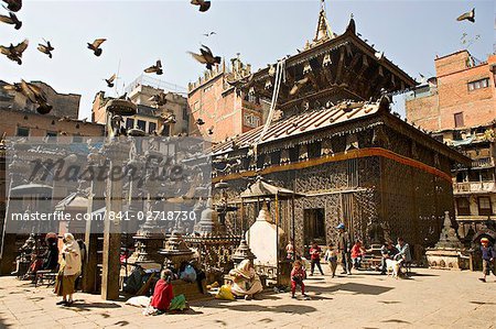 Seto Machendranath temple, close to Durbar Square, Kathmandu, Nepal. Pagoda style gilt roofed temple in a monastic courtyard now housing shops and market stalls.