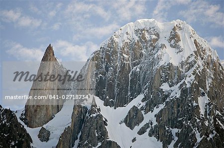 On the left the granite spire known as Lady Finger peak, or Bubulimating, summit 6,000m, high above Karimabad in the Karakoram mountains of the Northern Areas, Pakistan. On the right, Ultar Peak, 7388m and 73rd highest mountain in the world.