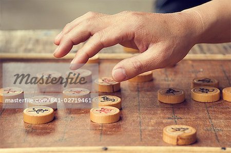 Chinese chess board and player's hand, Huangshan City (Tunxi), Anhui Province, China, Asia