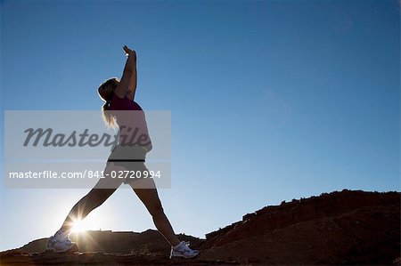 Woman stretching, Monument Valley Navajo Tribal Park, Arizona Utah border, United States of America, North America