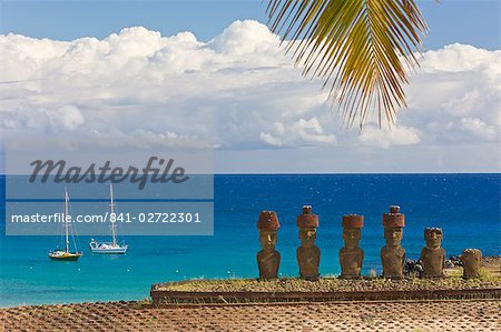 Anakena beach, yachts moored in front of the monolithic giant stone Moai statues of Ahu Nau Nau, four of which have topknots, Rapa Nui (Easter Island), UNESCO World Heritage Site, Chile, South America