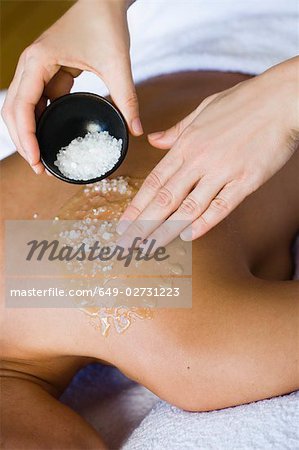 Hands massaging shoulder skin