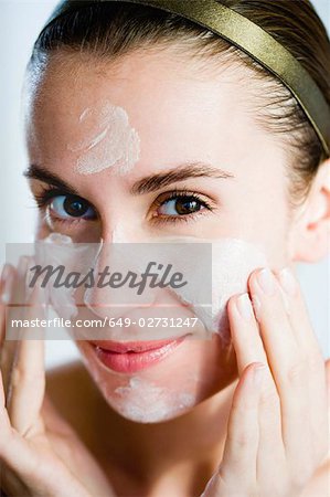 Woman putting face mask on
