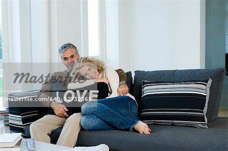 Man and woman on sofa with cushion