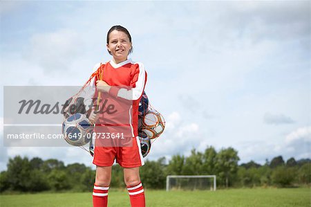 Footballer with bag of balls