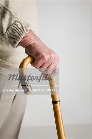 Senior man holding walking stick