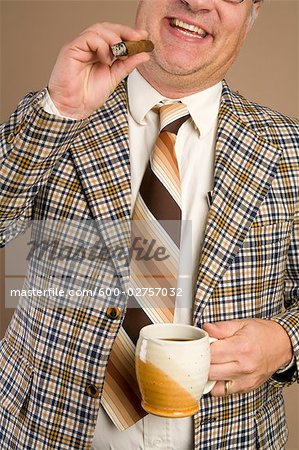 Retro Businessman Smoking a Cigar and Drinking a Cup of Coffee