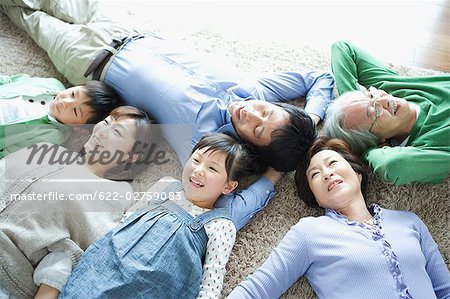 Family lying down on carpet