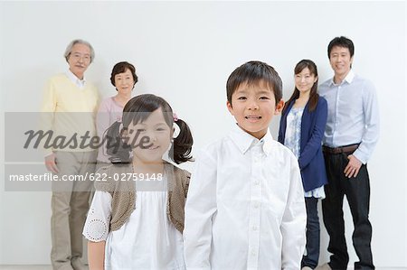 Asian family standing together in a v-shaped